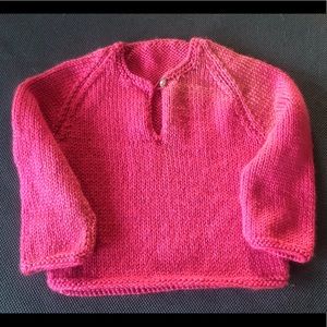 Hand-knit baby sweater with button detailing